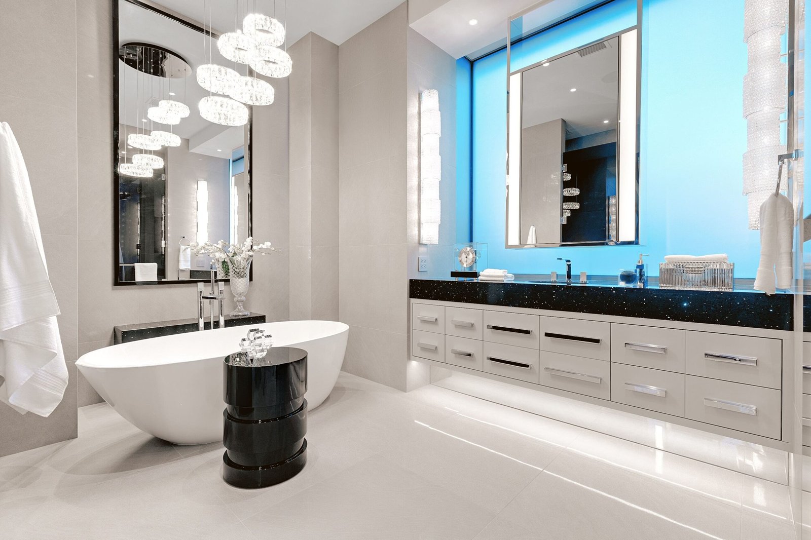 A modern minimalist bathroom featuring a sleek white bathtub, a floating vanity with a rectangular mirror, and minimalistic decor