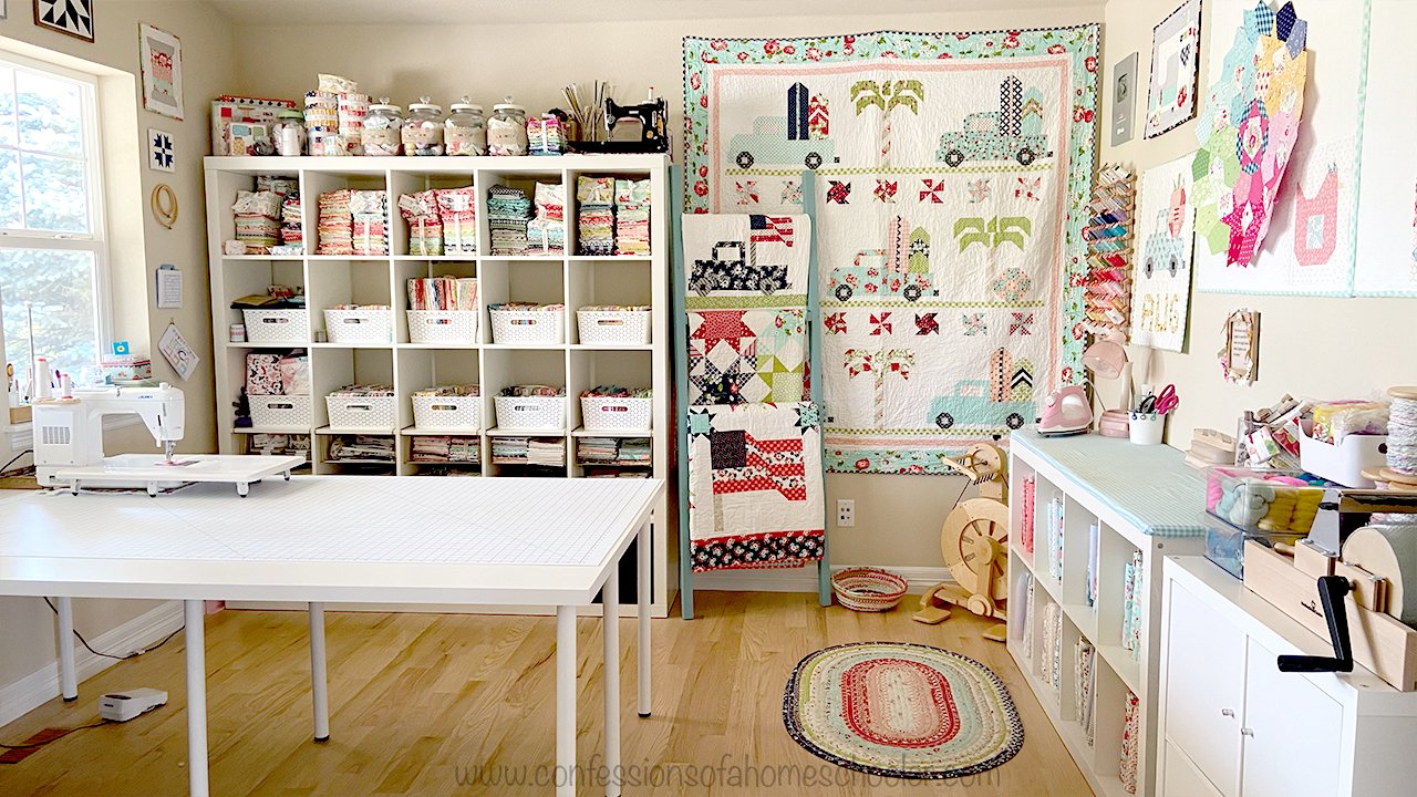 A collection of beautifully arranged home decor haberdashery items, including colorful fabrics, spools of thread, sewing needles, and scissors, on a wooden table